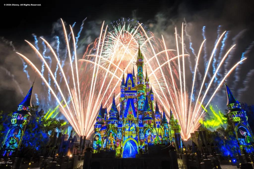 Cinderella Castle lit up with projections and fireworks going off overhead