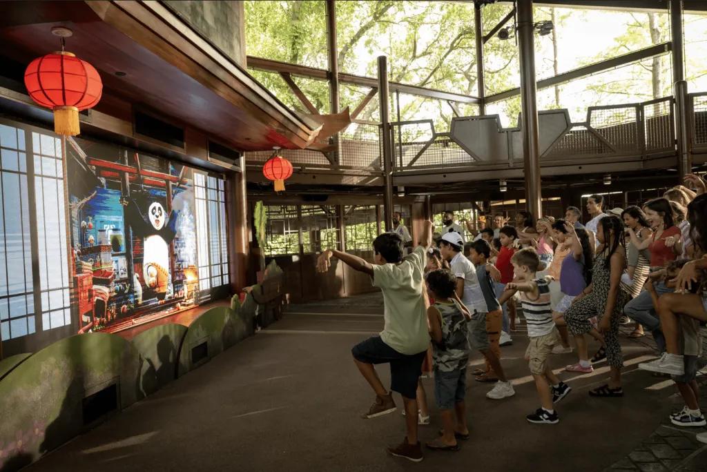 A group of children learning Kung Fu moves from a Kung Fu Panda show