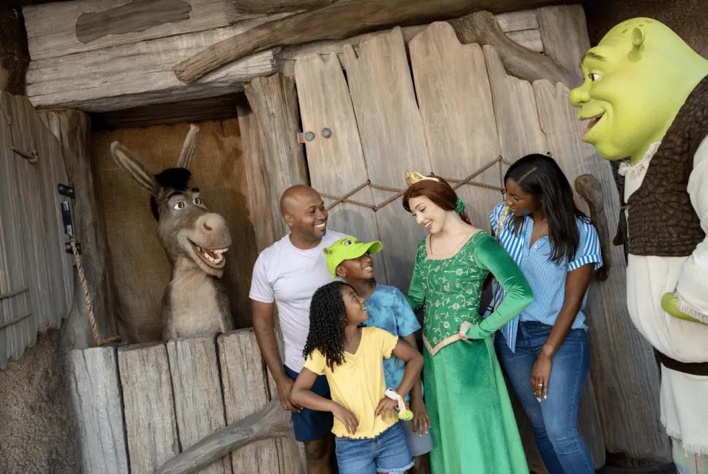 A family meeting Shrek, Fiona and Donkey in DreamWorks Land