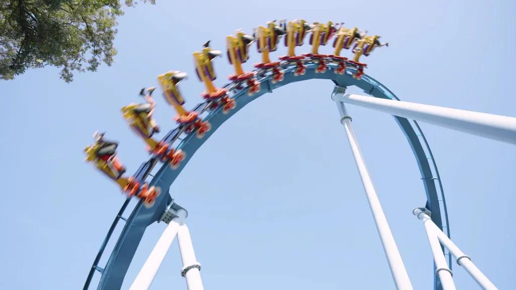 A rollercoaster going over an inversion against a clear blue sky