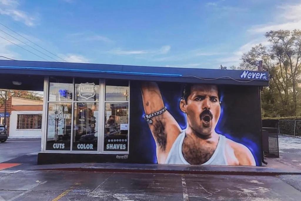 A mural of Freddie Mercury painted on the side of a barbours