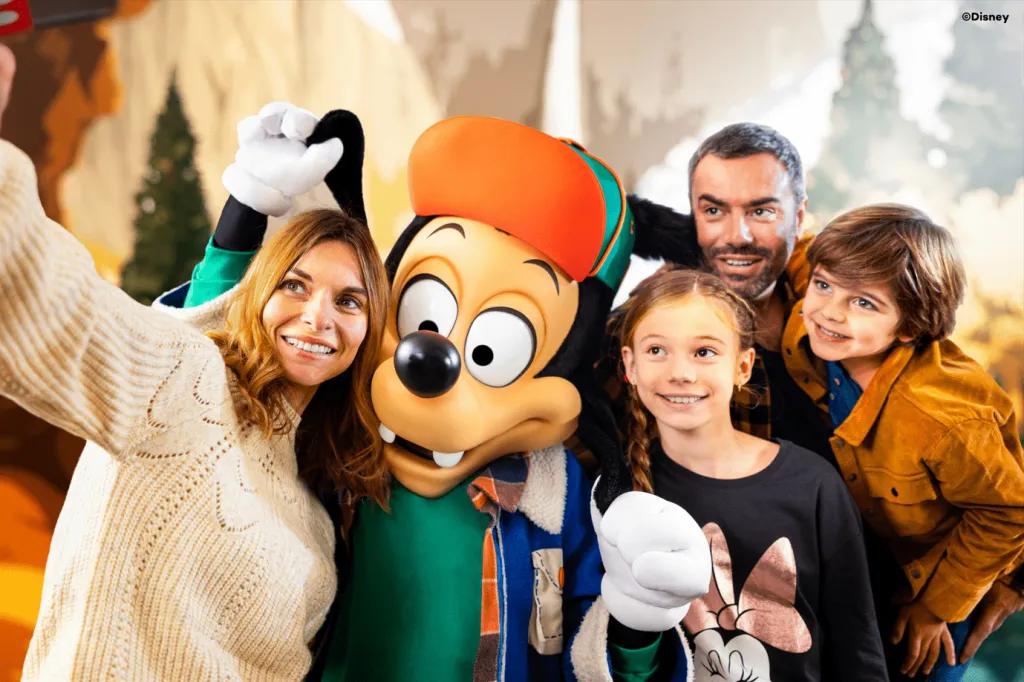 A family taking a selfie with Max Goof wearing a hat and winter coat