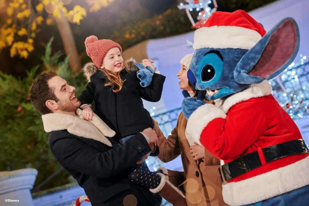 A family with a young girl meeting Stitch wearing a Santa costume
