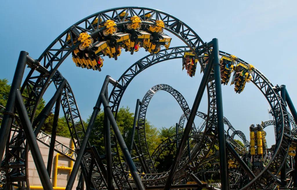 Cars going round a roller coaster with multiple loops and turns