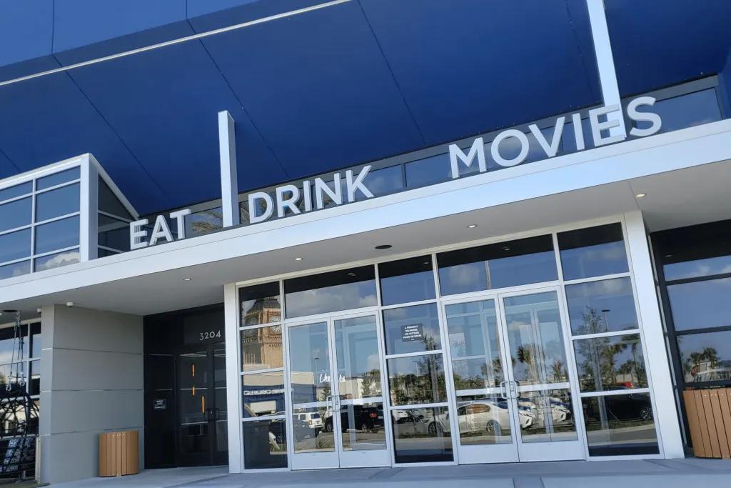 The entrance to a building with 'Eat, Drink, Movies' above the door
