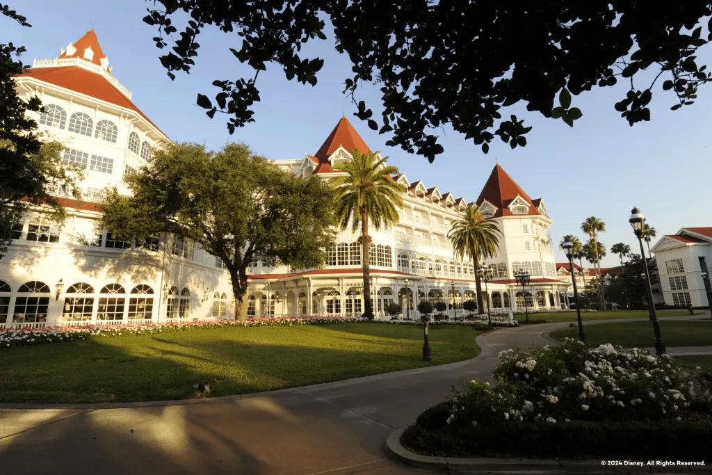 A victorian-era style hotel building with a white painted facade and red roof
