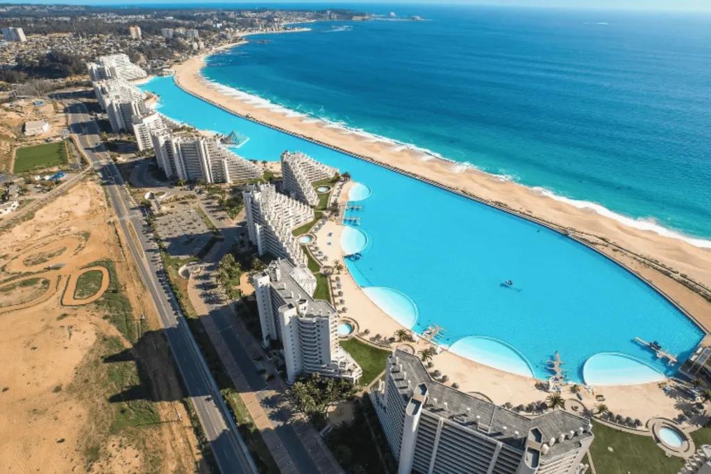There is a huge hotel complex behind a huge swimming pool which lines up with the coastline and sea on the other side of it. The pool is considered the world's largest swimming pool, stretching 20-acres long.