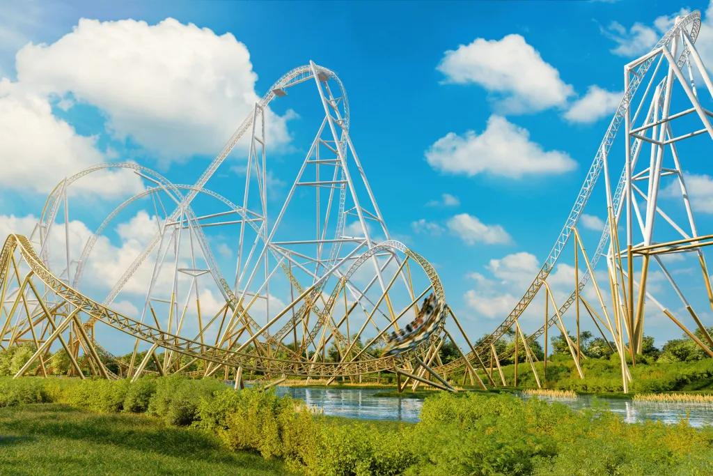A huge white and gold rollercoaster with many inversions and a huge drop.