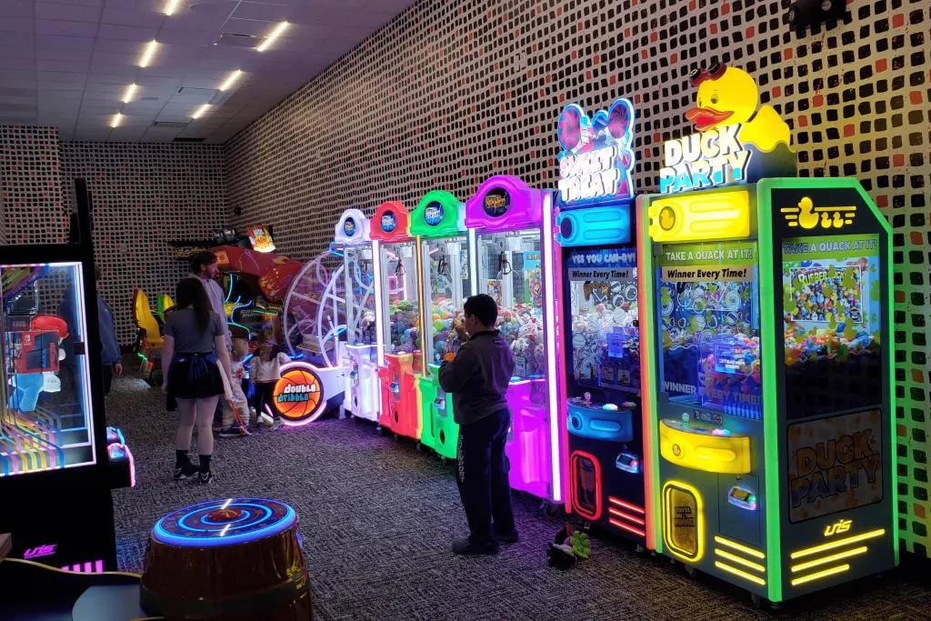 Tiled rooms with many arcade games lined up multi-coloured.