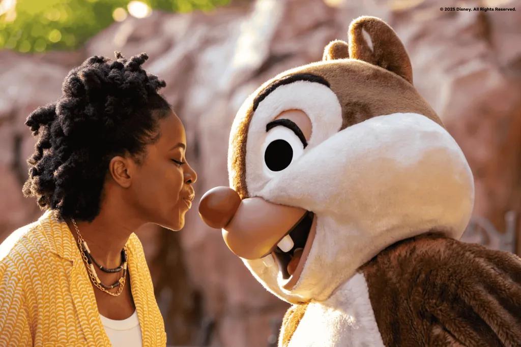 A woman kissing Dale the chipmunk on the nose