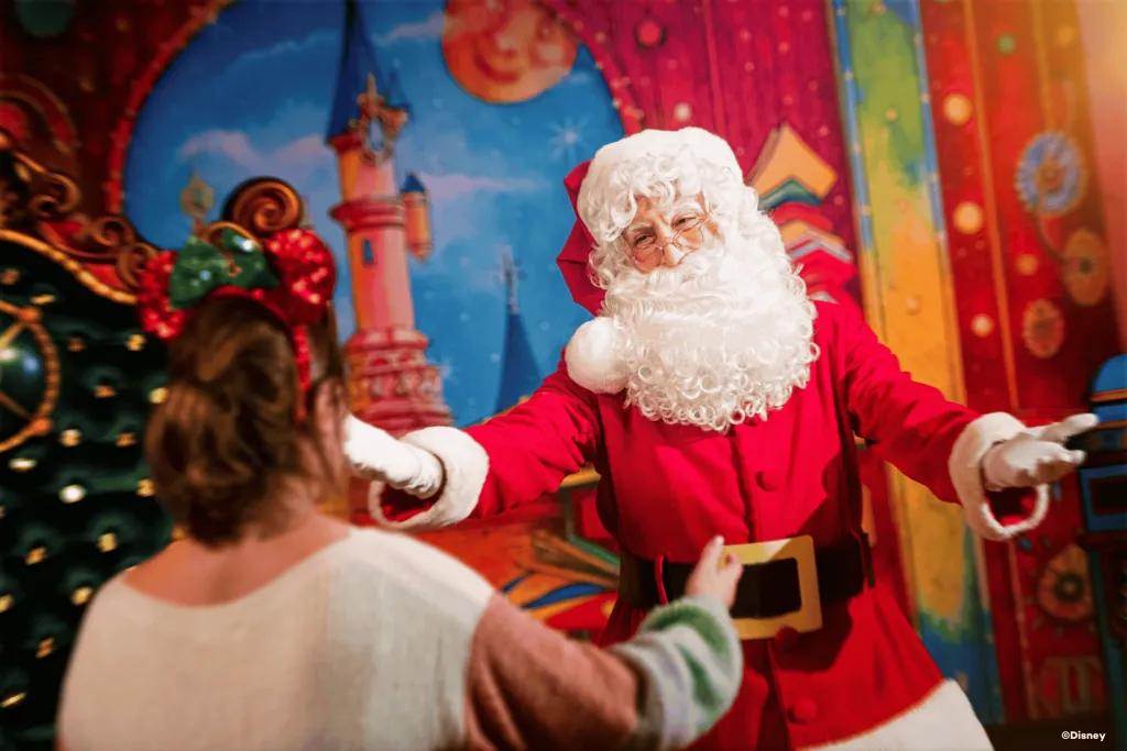 Santa holding his arms out towards a woman walking towards him