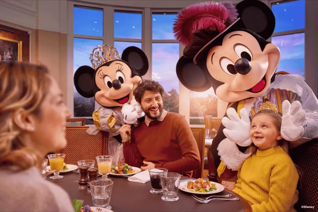 A family meeting Mickey and Minnie dressed in royal attire at Royal Banquet