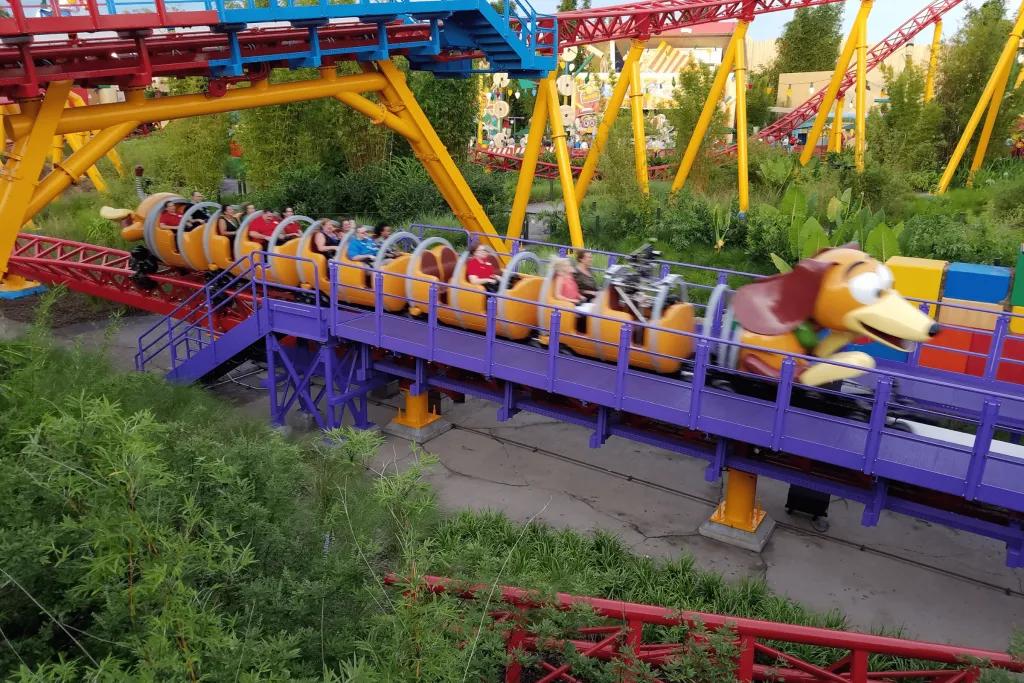A dog shaped rollercoaster zooming along the red and yellow tracks