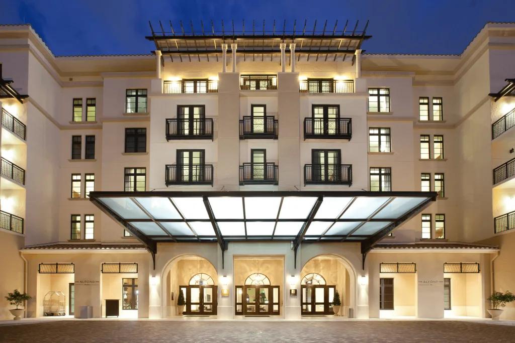 A large modern, sleek building coloured cream, with a large entrance.