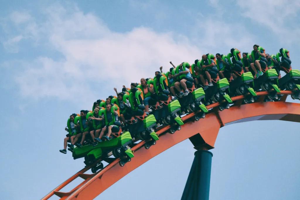 A green rollercoaster riding along the track 
