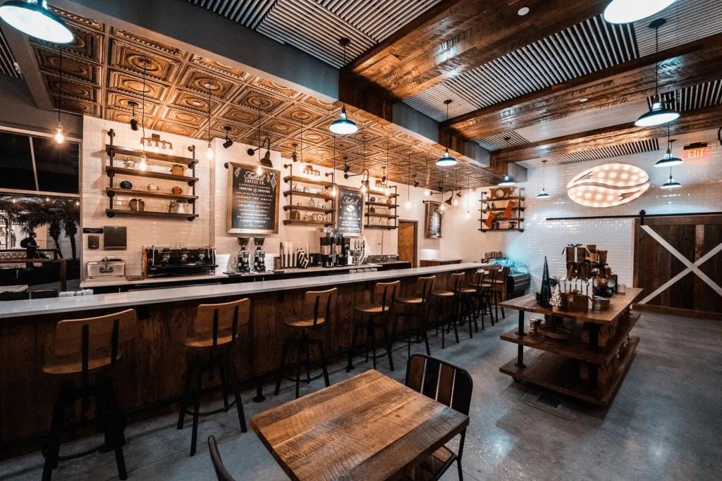 A coffee shop with bar stools and a wooden theme.
