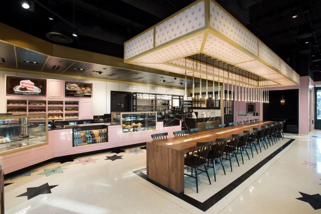 Pink and white decorated cafe with stars on the floor.