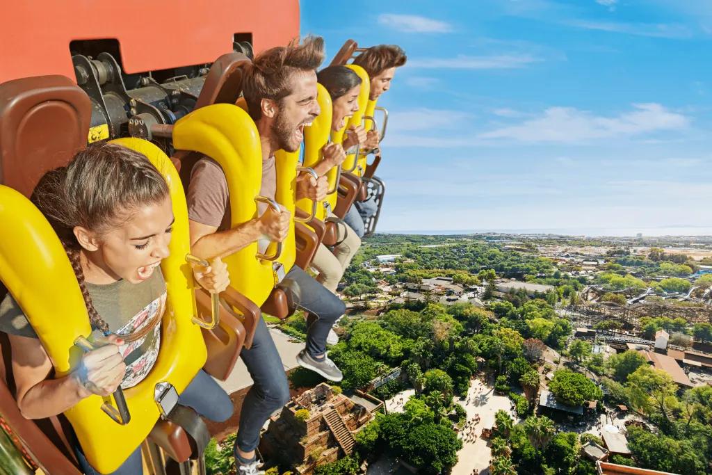 People waiting at the top of a drop tower about to drop