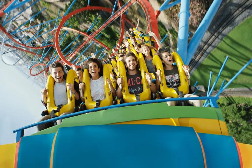 Riders in the front row of a rollercoaster about to go under an inversion