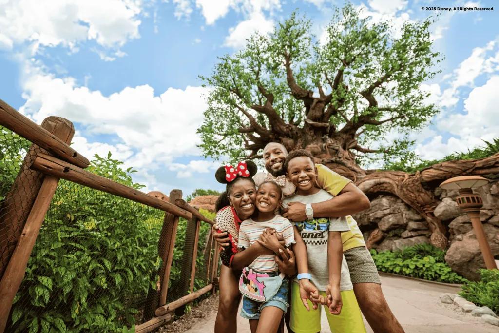 A family of four posing in front of the Tree of Life in Animal Kingdom