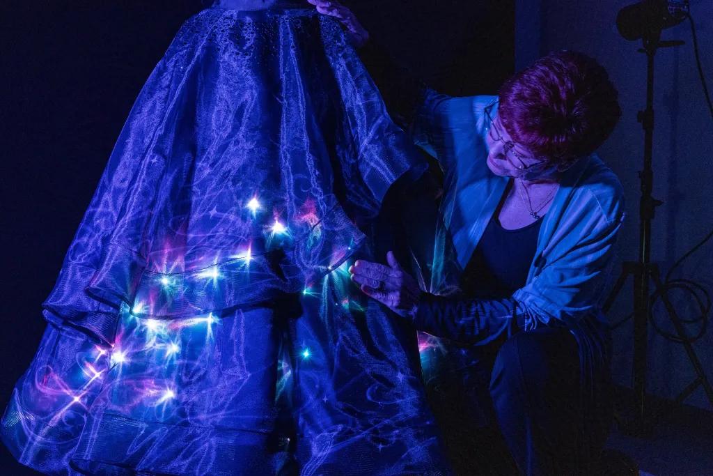 A Disney Imagineer adding lights to a parade float