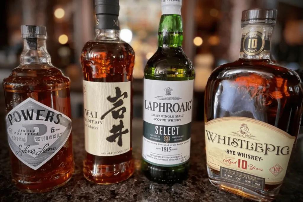 4 large bottles of alcoholic beverages from around the world.