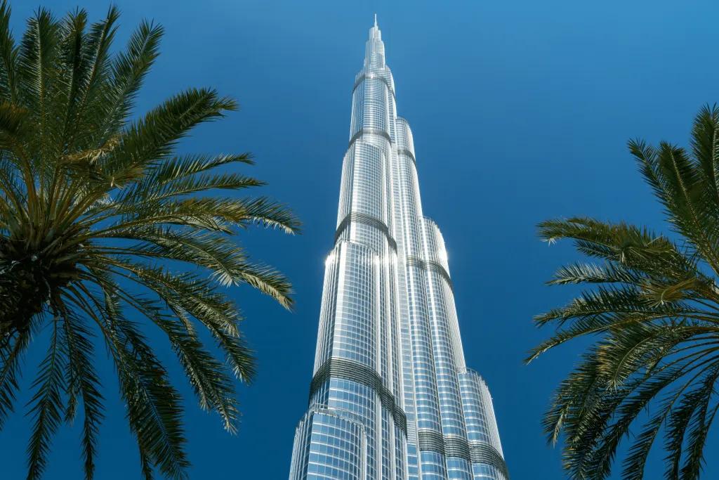 Huge skyscraper made of glass standing tall above Dubai.