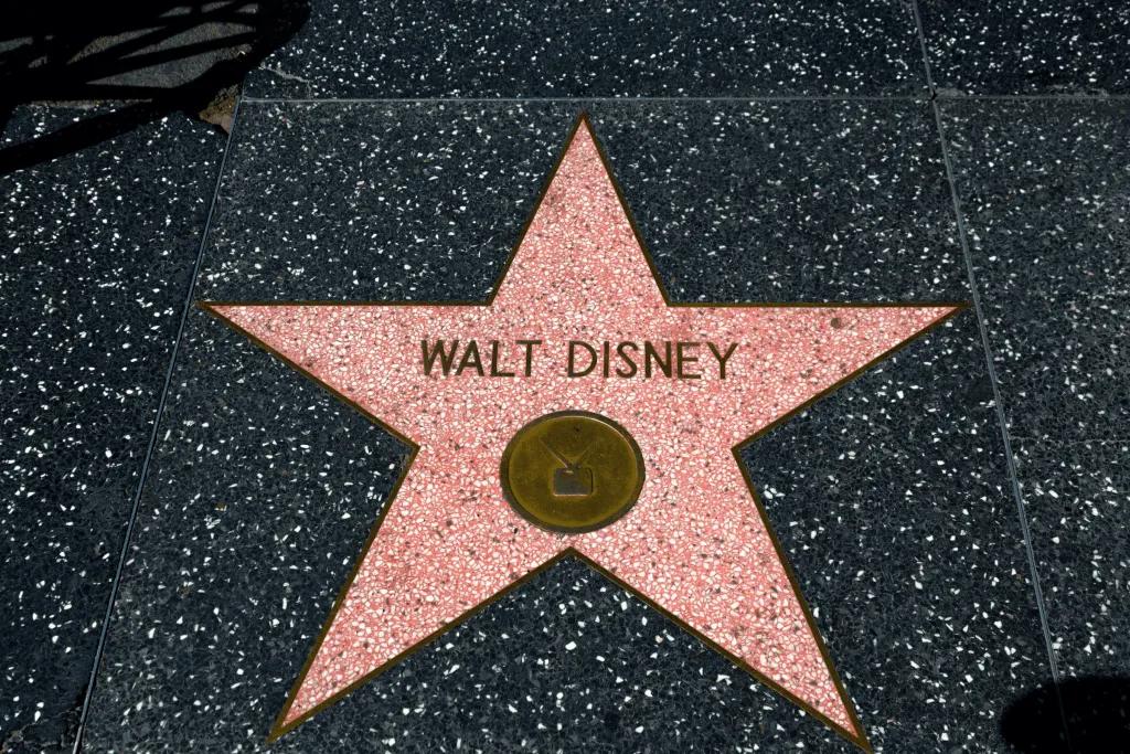 Walt Disney's name on the Hollywood Walk of Fame. Inside a pink star with a television symbol inside a gold circle.