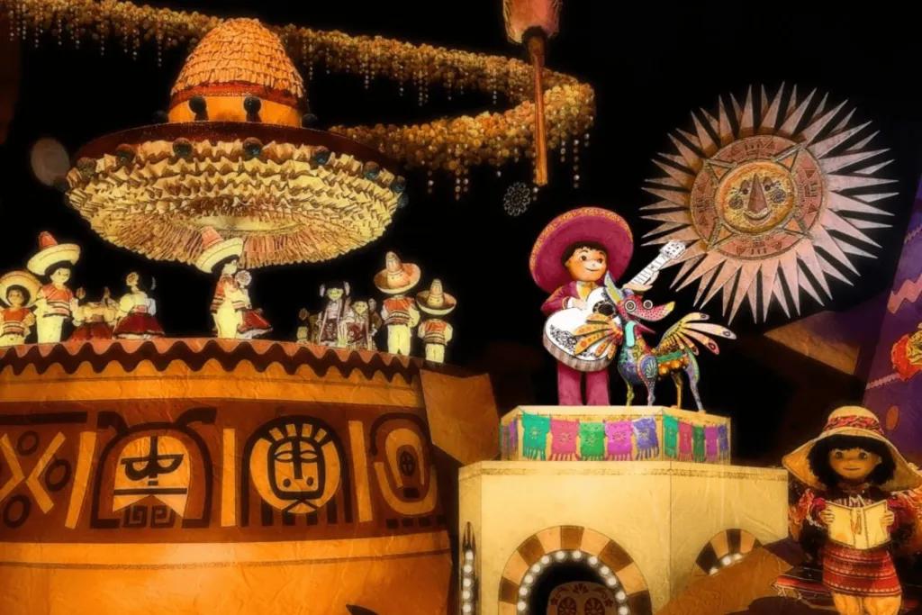 Little dolls of two famous Disney characters, Miguel in a sombrero and suit playing a guitar, and Dante the dog with wings. There are many Mexican cultural references.