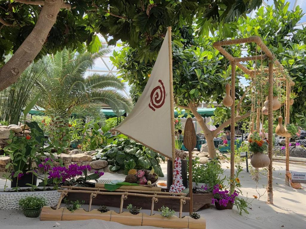 Moana's boat with plants inside inside the large Living with the Land greenhouse