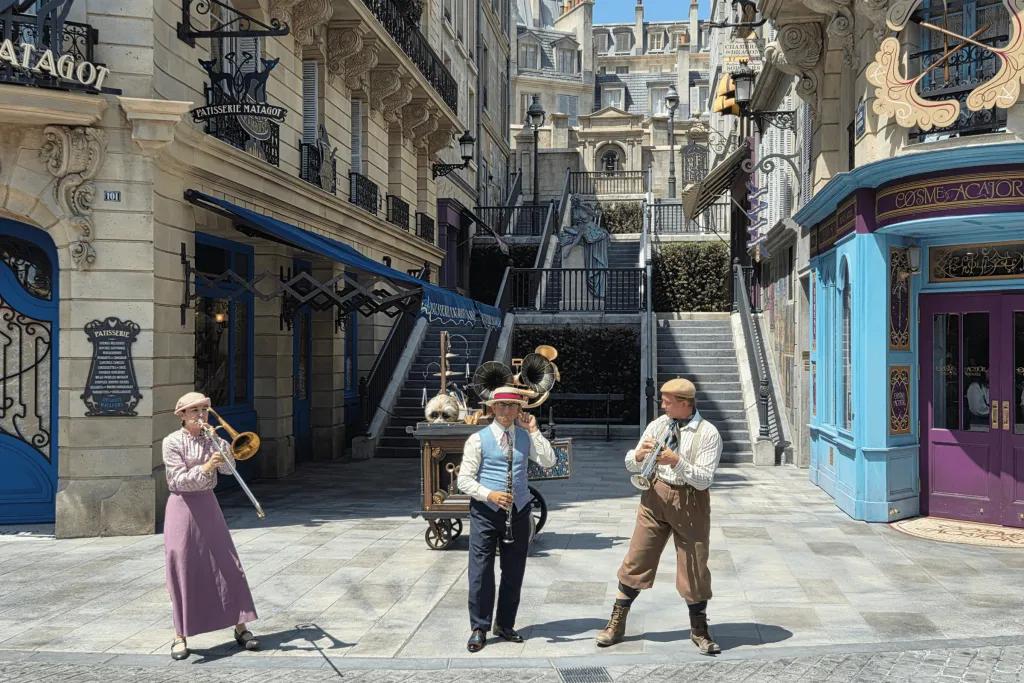 Empty streets of Paris with three musicians wearing old fashioned outfits playing different instruments including trumpets and clarinettist. 