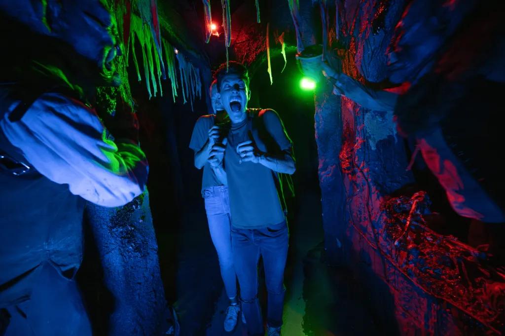A boy in a haunted house at Halloween Horror Nights being scared