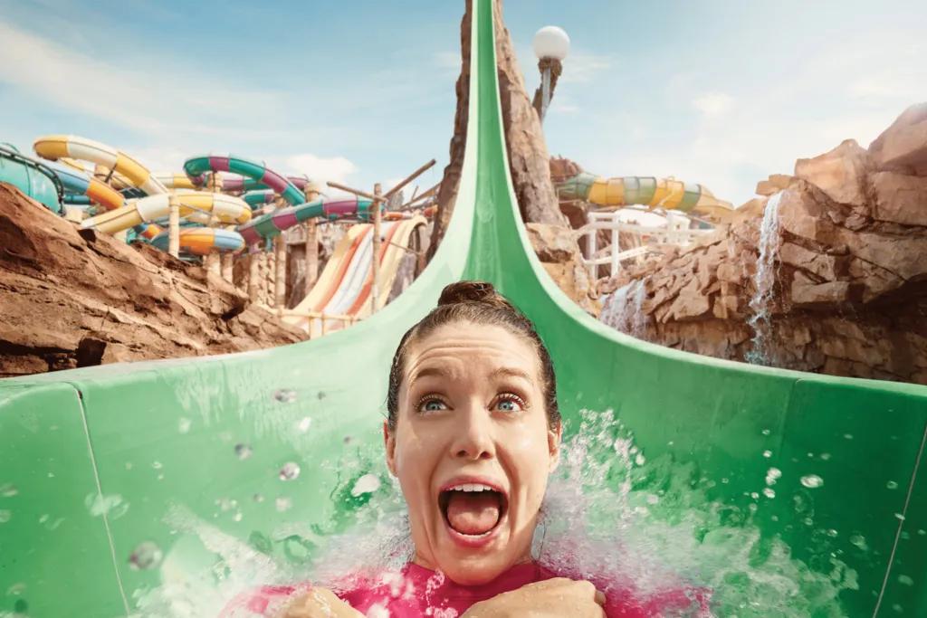 Woman screaming on a water slide which has a sheer drop.