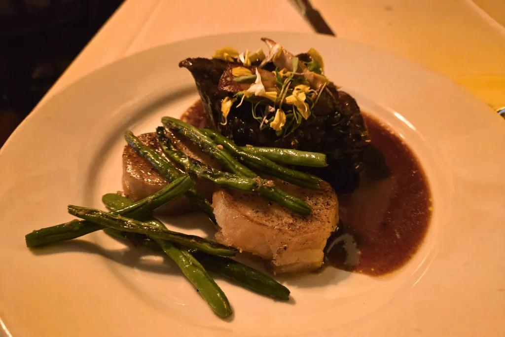 Beef with potatoes and green beans on top.