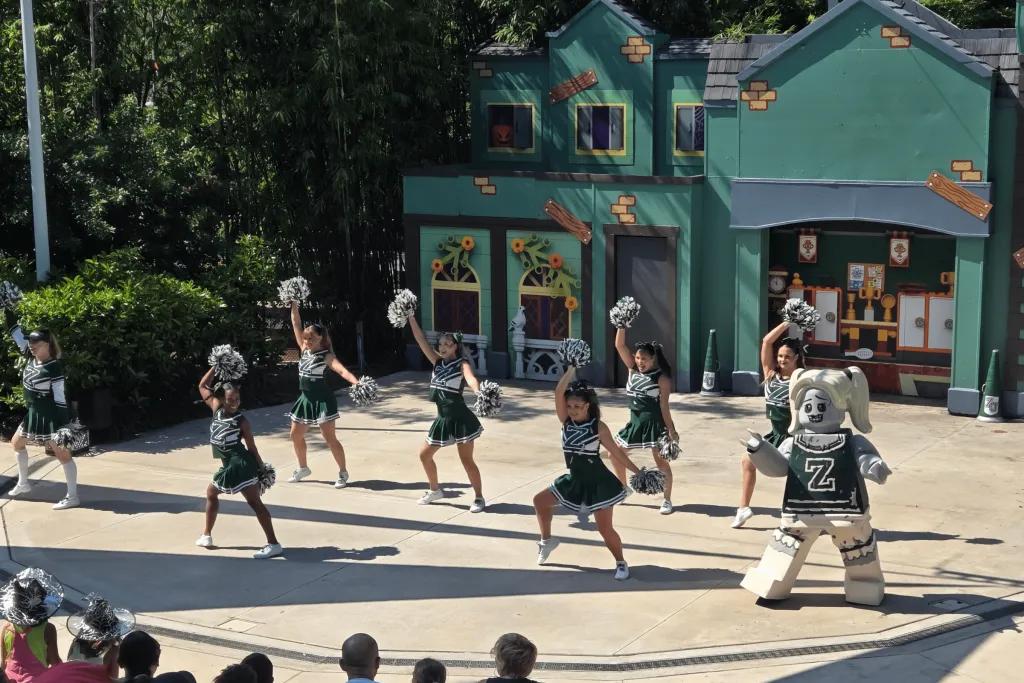 Dancers dressed in cheerleader costumes and a zombie cheerleader LEGO character.