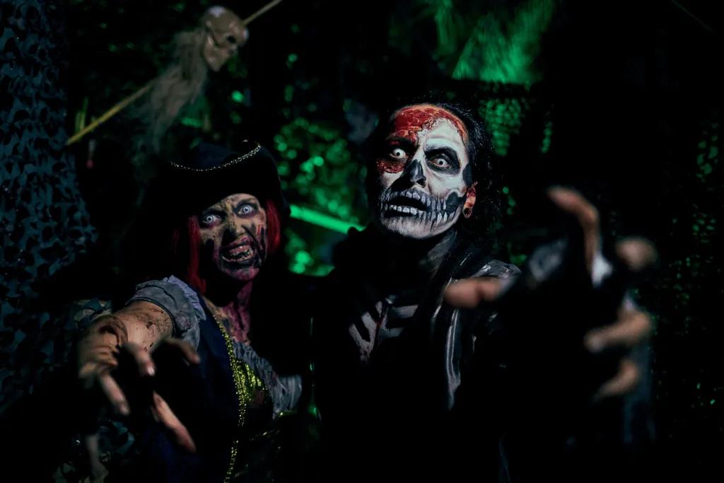 Two zombie pirates reaching their hands out to the screen