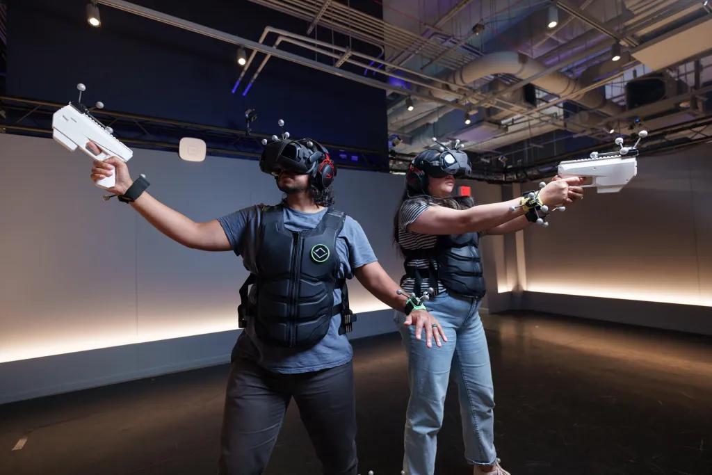 A man and woman standing next to each other in a VR experience