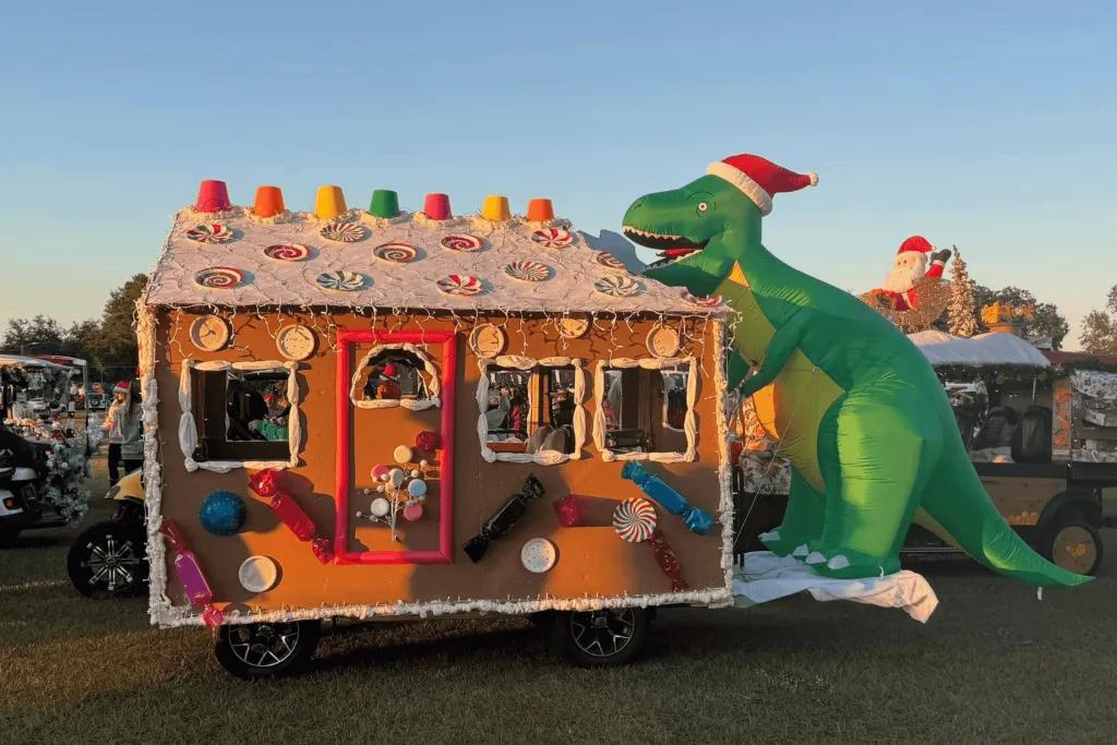 Pop up cart with gingerbread house and green inflatable dinosaur 