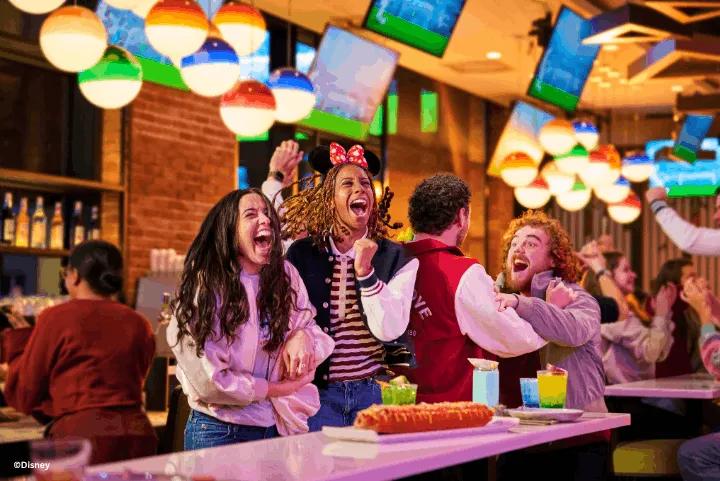 Guests at the Sports Bar & Lounge presented by Coca-Cola, Disney Village®