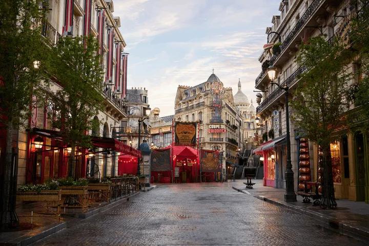 Cobblestone Parisian street with a Coupe de Quidditch banner, part of the Wizarding World's Ministry of Magic area at Epic Universe