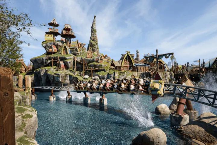 Roller coaster train crossing water at the Isle of Berk, the How to Train Your Dragon land at Epic Universe