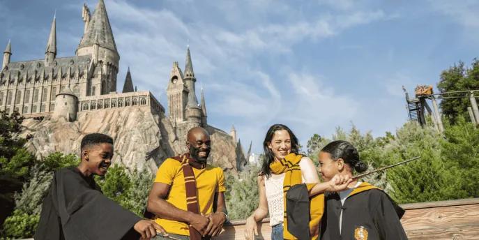 A family posing outside Hogwarts Castle in Universal Orlando Resort