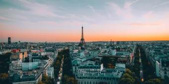 View of Paris from above, with streets and buildings leading to the Eiffel Tower
