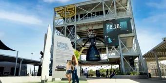 A woman and young girl standing in front of a rocket experience at Kennedy Space Center