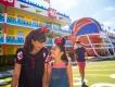 A woman and girl walking in front of a hotel designed to look like an American football pitch