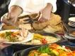 A chef serving fresh salt-crusted salmon and roasted vegetables at a Disneyland Paris buffet.