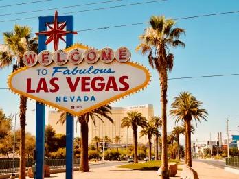 Welcome to Las Vegas sign in front of blue sky and palm trees