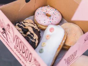 A box of iced ring and filled doughnuts from Voodoo Doughnuts