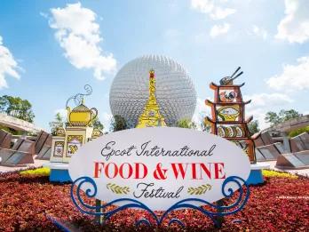 A sign reading "EPCOT International Food and Wine Festival" in front of Spaceship Earth