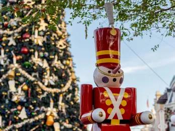 A toy solder in front of a giant Christmas tree 